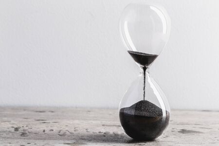 Close up hourglass on tableの写真素材
