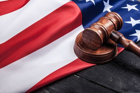 Wooden gavel and USA flag on table close upの写真素材