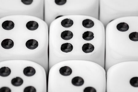 Rolling dice on a wooden deskの写真素材