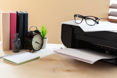 White scanner or printer machine on a table