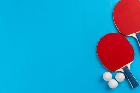 table tennis racket and ball on blue background