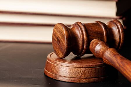 Wooden gavel and juridical books