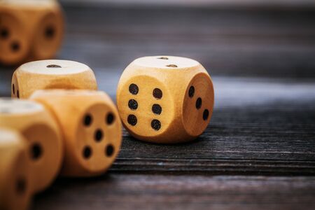 Dice on wooden table. Background for casino games. Close up.の写真素材