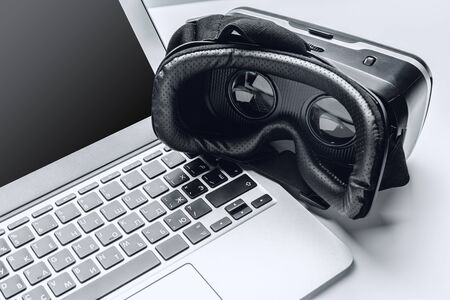 VR glasses and laptop on a table. Close up.
