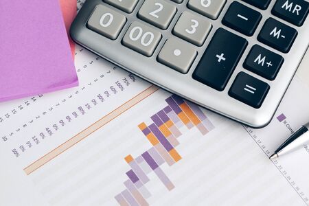 Business still life with calculator on table in office. Close up.