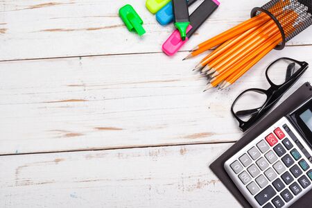 school supplies, stationery accessories on wooden background,Space text,top view. Close up.