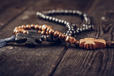wooden cross on wood background. Close up.の写真素材