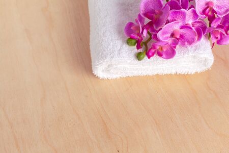 clean soft towels with flower on wooden tableの写真素材