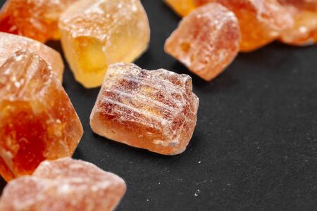 brown sugar rock organic crystalline close up on dark backgroundの写真素材