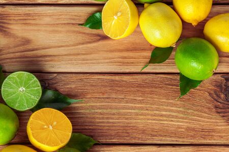 lemons and limes on wooden padの写真素材