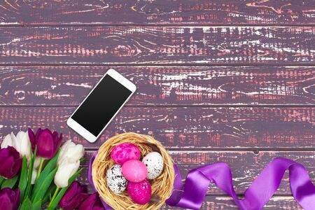 easter, holidays, tradition and object concept - close up of colored easter eggs, tulip flowers and...