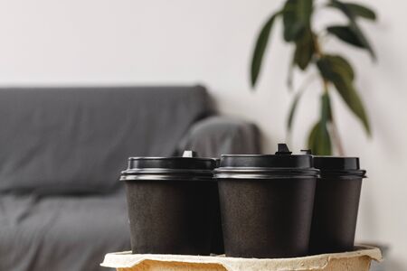 Black take away coffee cups in holderの写真素材