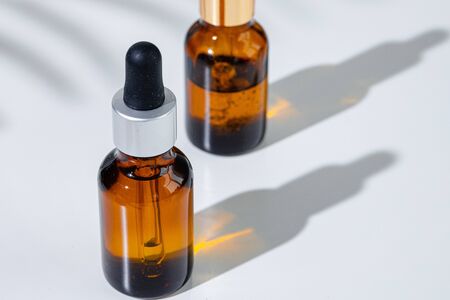 Oily skincare moistrizing brown glass jar with pipette close upの写真素材