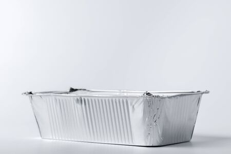Foil food box with takeaway meal on white background close upの写真素材