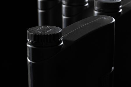 Engine oil bottle on black background.