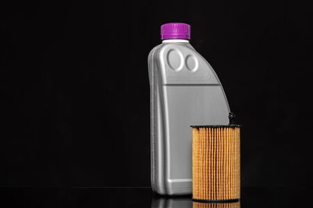 Car oil filters and motor oil can on dark backgroundの写真素材