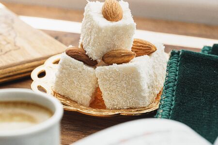 Coffee cup with oriental sweets on wooden table close upの写真素材