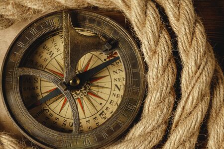 Ship rope and compass on wooden background, close upの写真素材