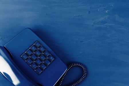 Retro telephone of blue color on classic blue backgroundの写真素材