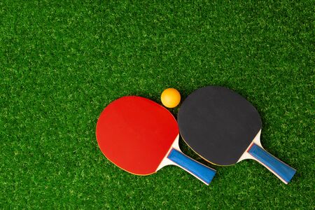 table tennis  rackets and ball on grassの写真素材
