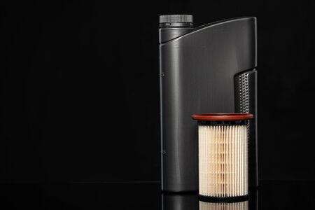 Car oil filters and motor oil can on dark background, close up.の写真素材