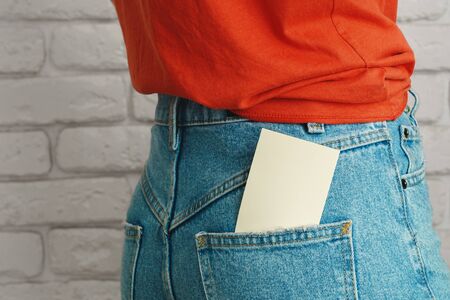 Girl's hand holding blank white business card close upの写真素材