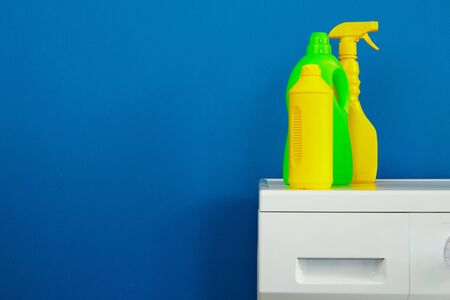 Bottle of detergent whith washing machine, indoors. Close up.の写真素材