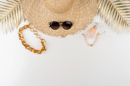 Straw hat and sunglasses top view on white background. Close up.の写真素材
