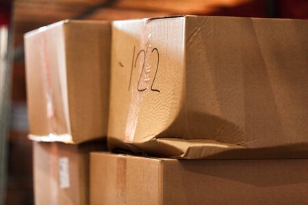 Modern warehouse shelves with pile of cardboard boxes. Close up.の写真素材