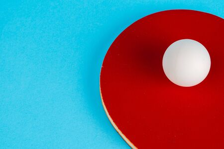 Red table tennis  racket on a blue backgroundの写真素材