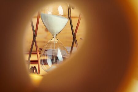 Close up of book page on a background of hourglassの写真素材