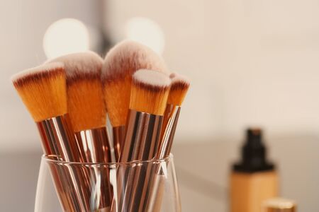 Decorative cosmetics and tools on dressing table in makeup room, close up