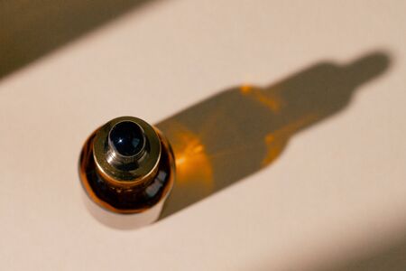 Oily skincare moistrizing brown glass jar with pipette close upの写真素材