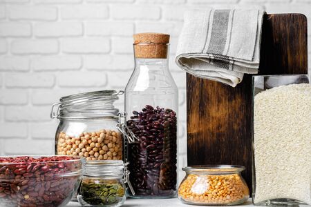 Raw cereals or beans in glass jars close up. Vegan and vegetarian food. Close up.