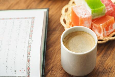Coffee cup with oriental sweets on wooden table close up