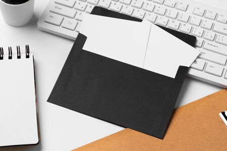 Blank business cards with supplies and keyboard on office table. Close up.の写真素材