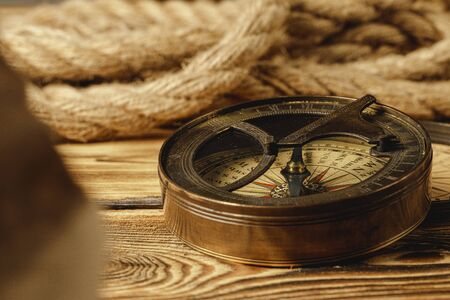 Ship rope and compass on wooden backgroundの写真素材