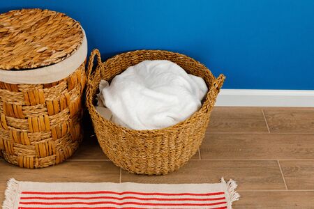 Pile of clothes in laundry basket indoors.の写真素材