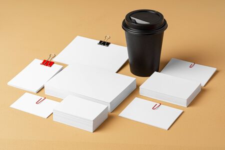 Blank takeaway coffee cup and white businesscards with copy spaceの写真素材