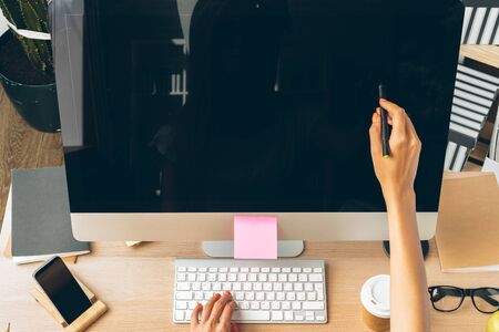 Stay safe and working from home. Young woman working at home.の写真素材