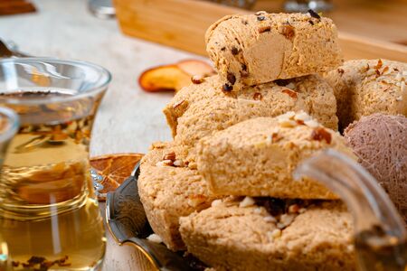 Turkish halva with tea in a glass cup close upの写真素材
