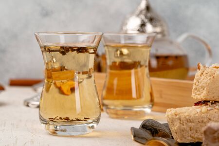 Turkish halva with tea in a glass cup close up on tableの写真素材