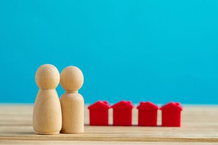 Wooden little family toys. House purchase, sale, rent concept