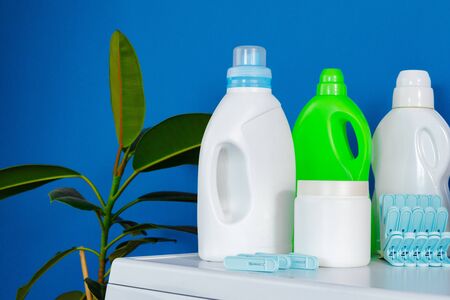 Bottle of detergent whith washing machine, indoorsの写真素材