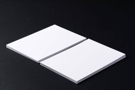 White blank business cards on dark black background, copy spaceの写真素材