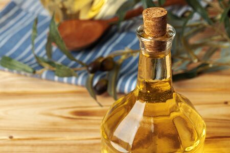 Olive oil bottle on wooden table.の写真素材