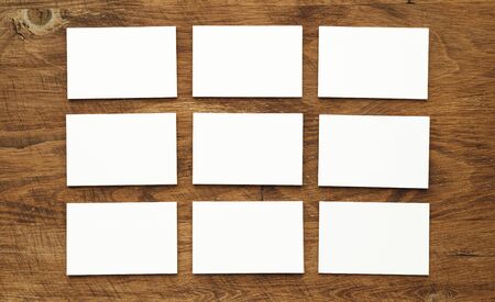 Stacks of businesscards with copy space on wooden background