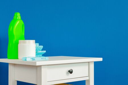 Blue clothes pins on white wooden table