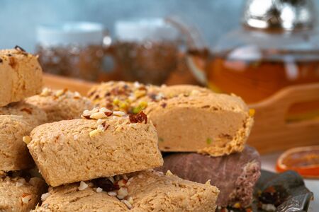 Turkish halva with tea in a glass cup close up
