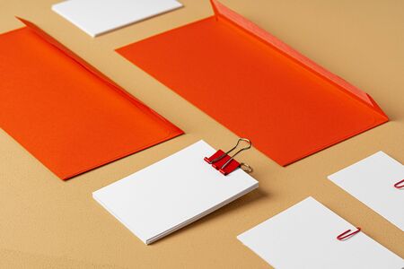 Red and white blank branding paper on beige backgroundの写真素材